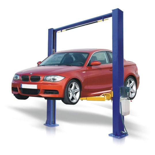 Red passenger car raised on a two-post hydraulic vehicle lift.