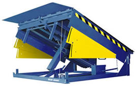Industrial hydraulic dock leveler shown in a raised loading position.