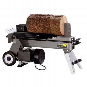 Portable log splitter holding a large section of timber on its hydraulic splitting bed.