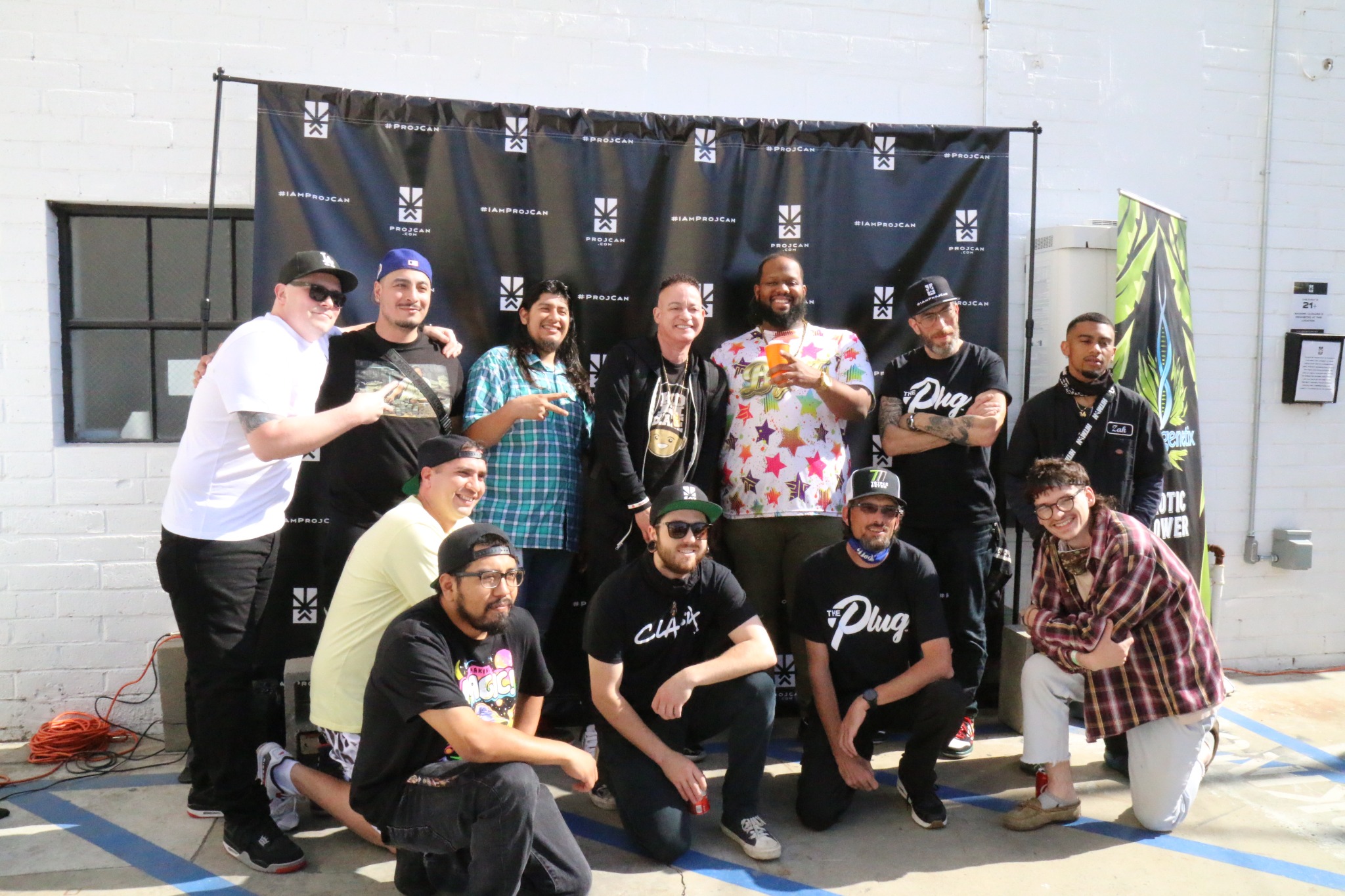 I’m ProjCan participants and team members gathered in front of the campaign step-and-repeat backdrop at Project Cannabis headquarters.