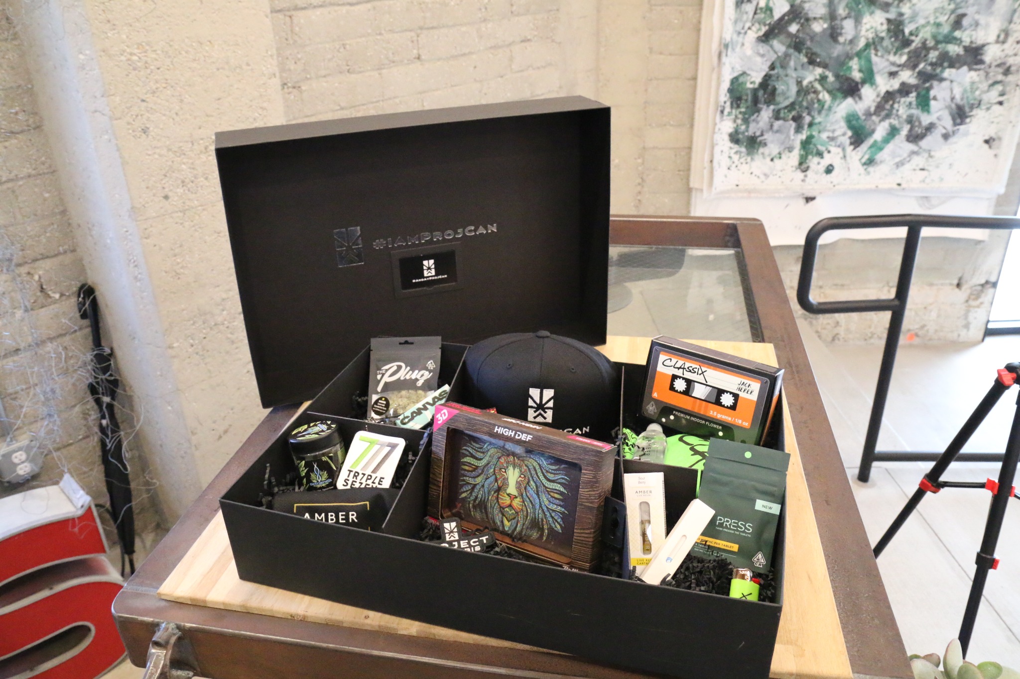 Wide view of an open black I’m ProjCan member gift box filled with branded products and merchandise at the appreciation event.
