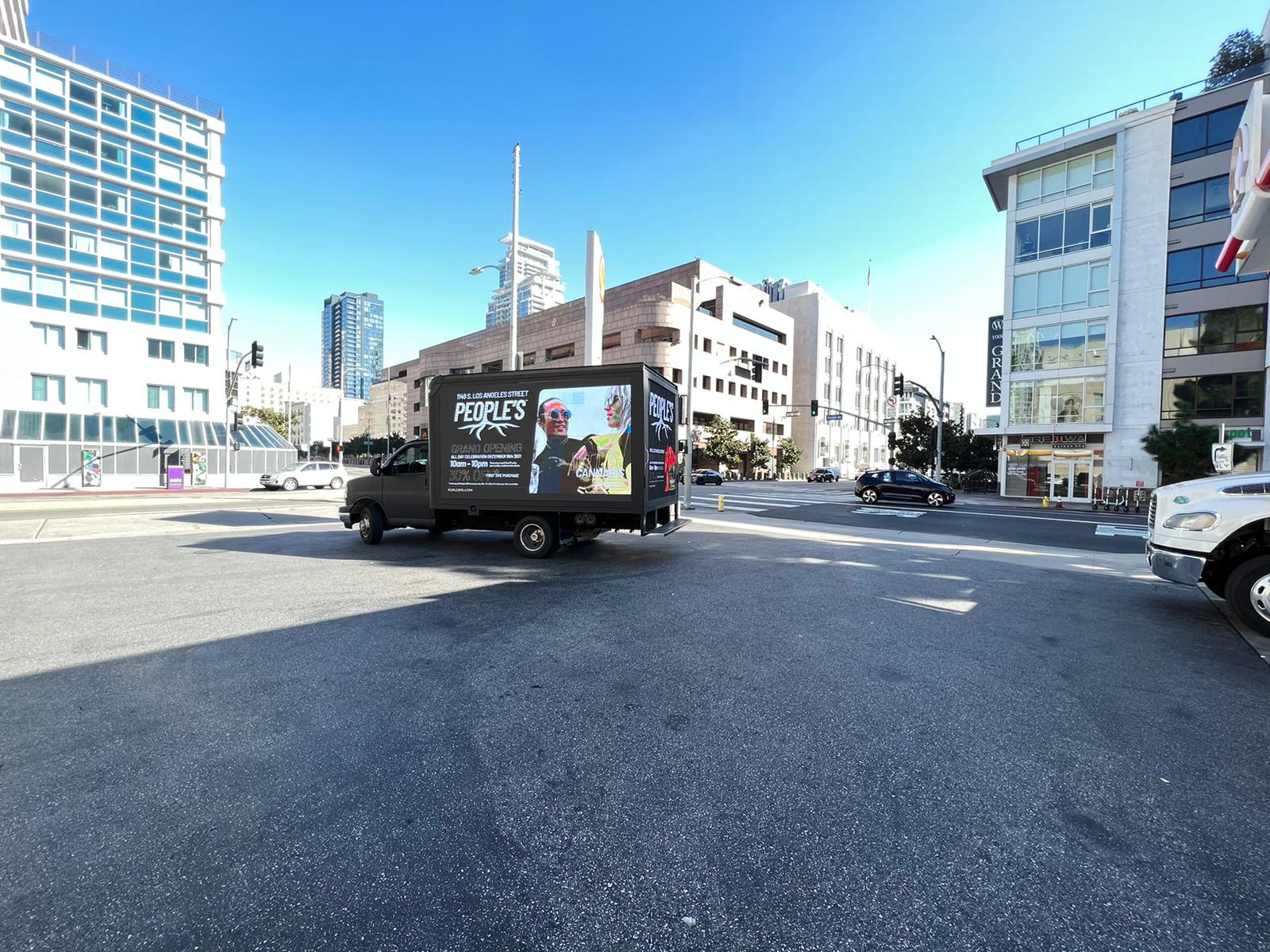 People’s digital advertising truck carrying Grand Opening creative at a downtown Los Angeles intersection.